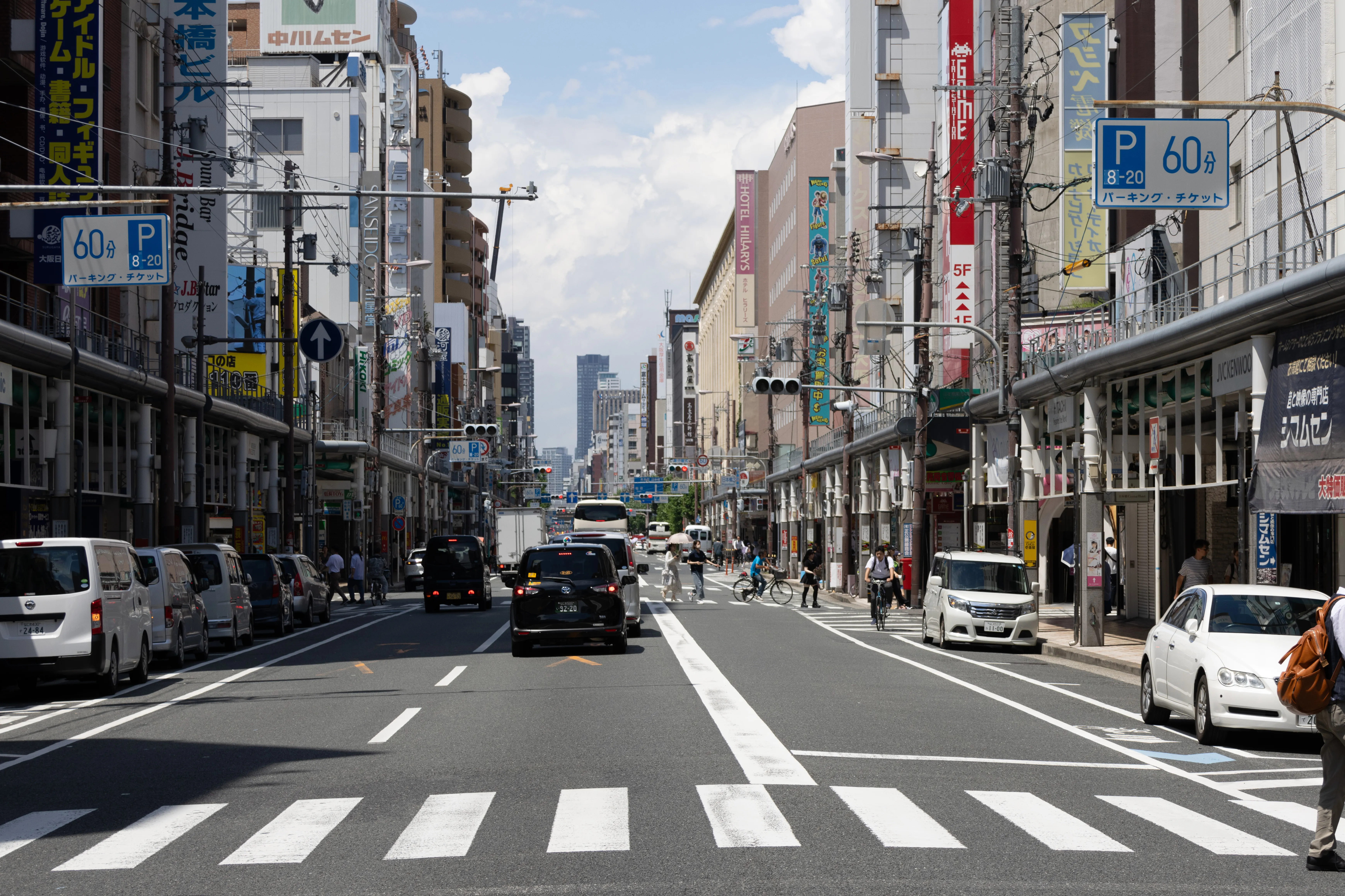 The Den Den Town streetscape in Nipponbashi, Osaka, lined with anime and electronics shops