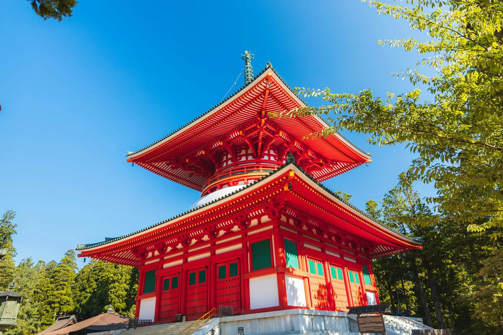 The vermilion Konpon Daitō pagoda of the Danjo Garan rising beside cedar forest at Koyasan