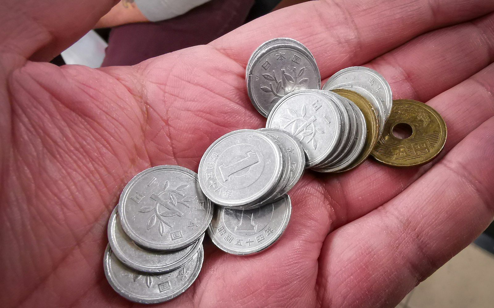Japanese yen coins held in a hand