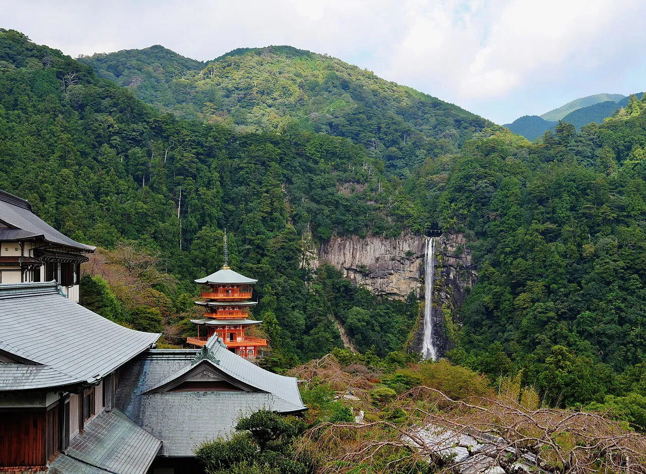 The vermilion three-storied pagoda of Seiganto-ji beside the tall Nachi Falls, Kumano Kodo, Wakayama