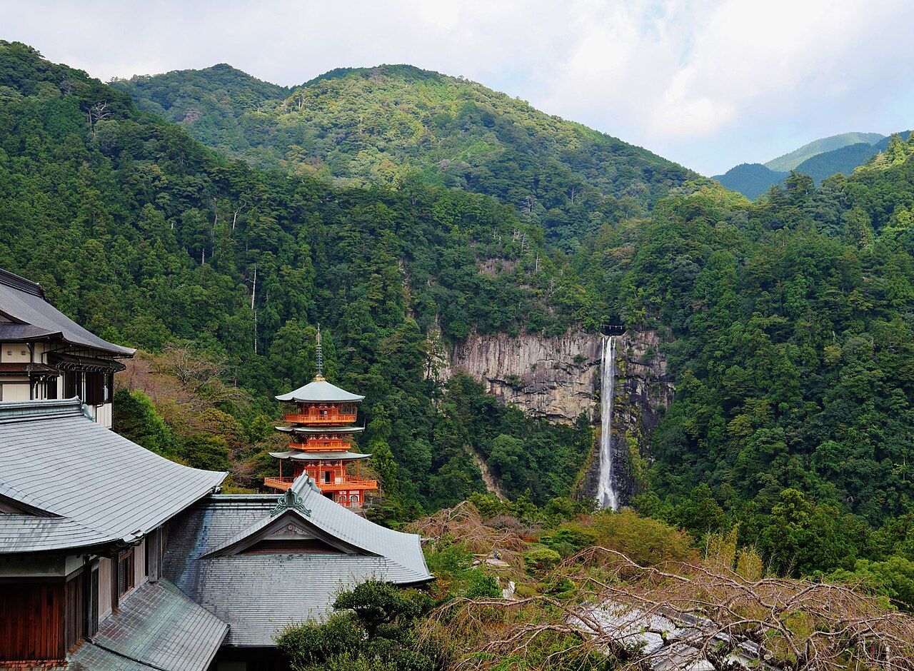 The vermilion three-storied pagoda of Seiganto-ji beside the tall Nachi Falls, Kumano Kodo, Wakayama